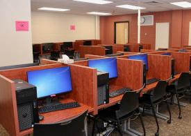 computer lab with wooden dividers between computers