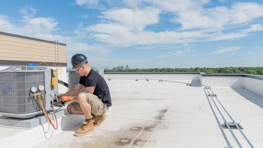 Refridgeration contractor working on roof