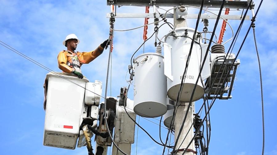 Electrician on crane working on power line